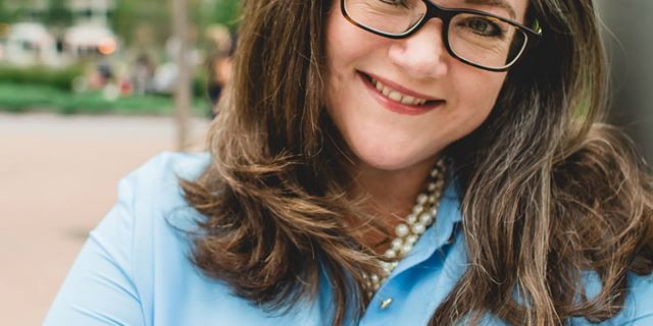 Picture of Tiffany Palmer arms folded smiling in front of the LOVE statue